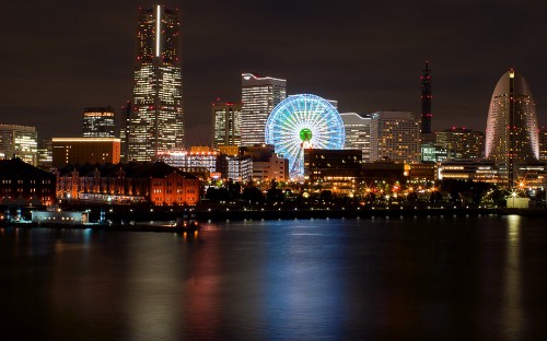 Image ferris wheel near city buildings during night time