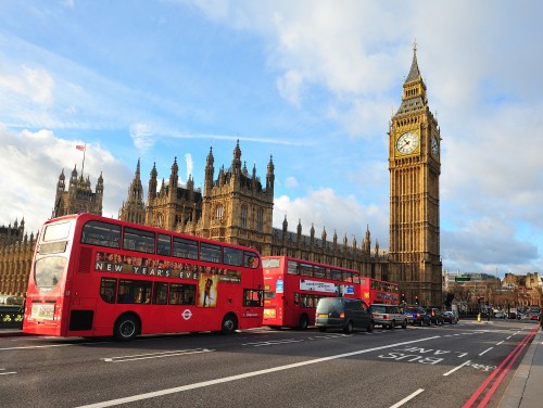 Image red double decker bus on road near big ben during daytime