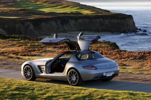 Image white and black porsche 911 on green grass field during daytime