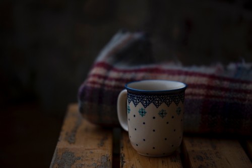 Image white and blue floral ceramic mug on brown wooden table