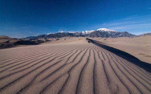 Image brown sand under blue sky during daytime