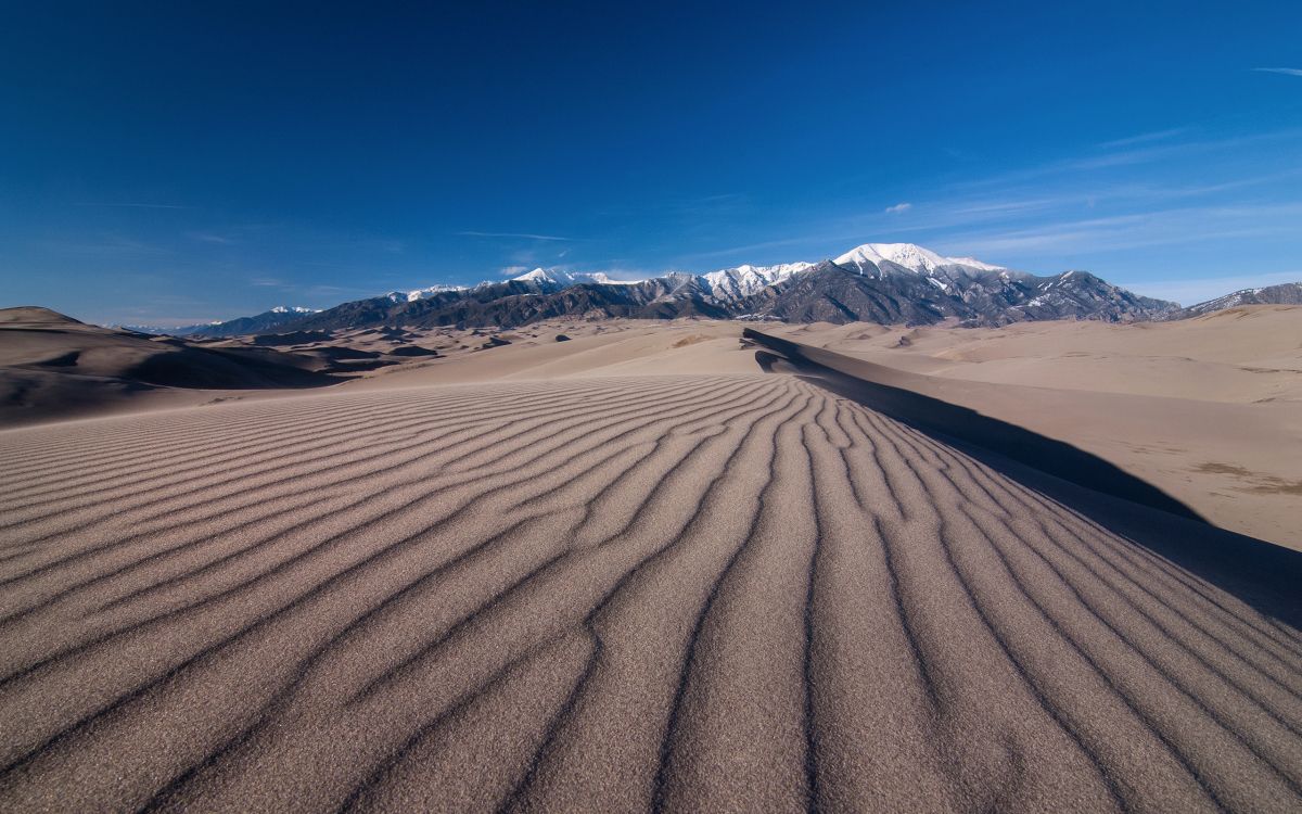 brown sand under blue sky during daytime