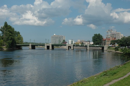 Image white concrete building near body of water under blue sky during daytime