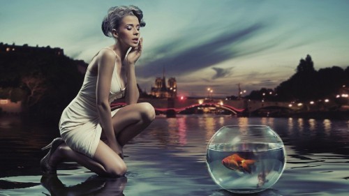 Image woman in white tank top and white shorts sitting on water