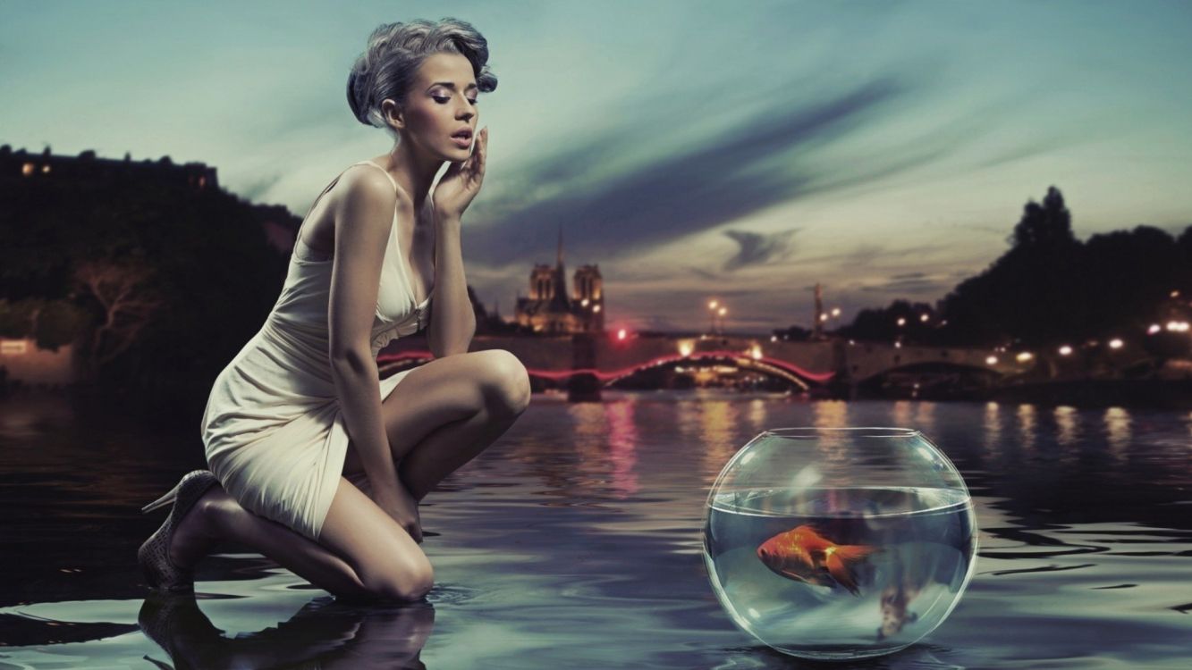 woman in white tank top and white shorts sitting on water