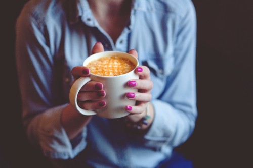 Image person holding white ceramic mug