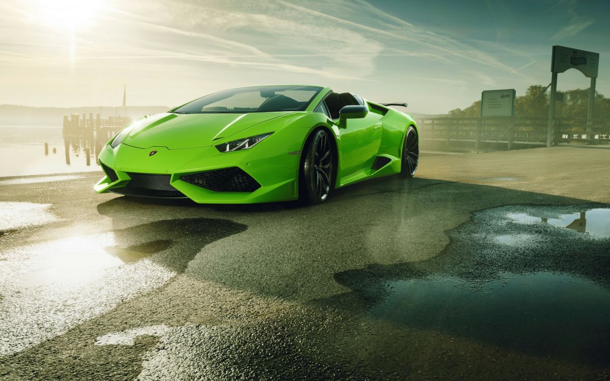 green lamborghini aventador on brown sand during daytime