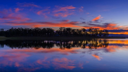 Image body of water near trees during sunset