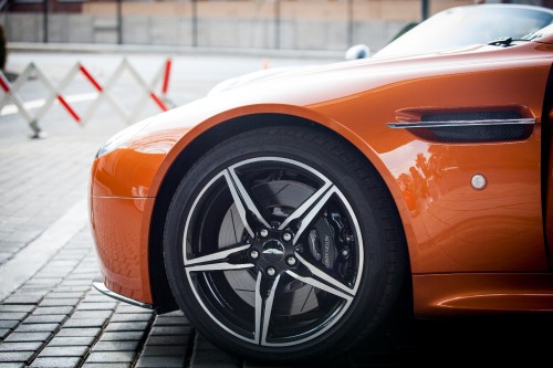 Image orange and black car on gray pavement