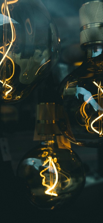 Image clear glass light bulb turned on in dim light