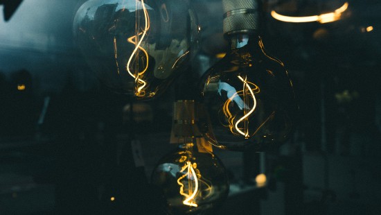Image clear glass light bulb turned on in dim light