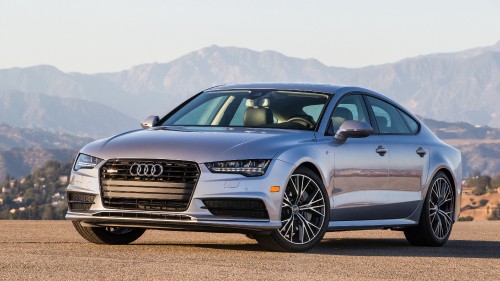 Image black audi a 4 coupe on brown field during daytime