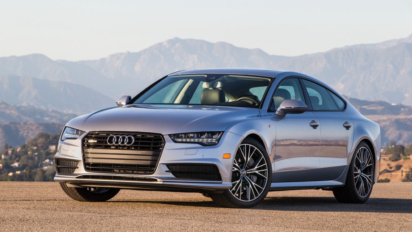 black audi a 4 coupe on brown field during daytime