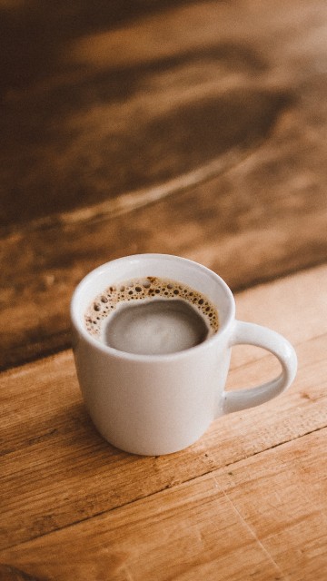 Image white ceramic mug on brown wooden table