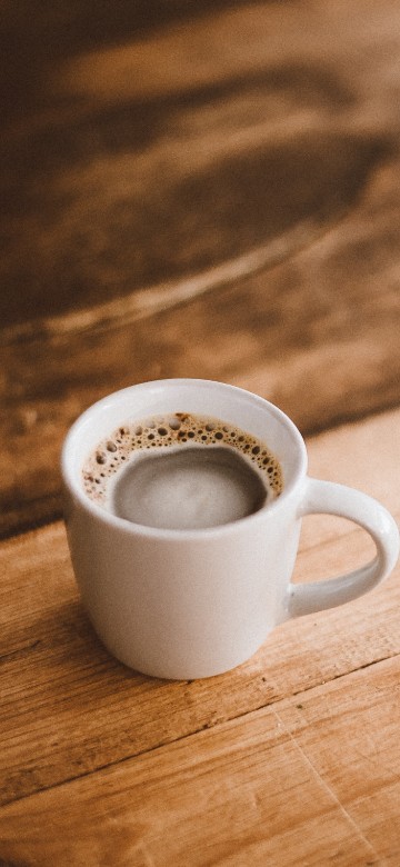 Image white ceramic mug on brown wooden table