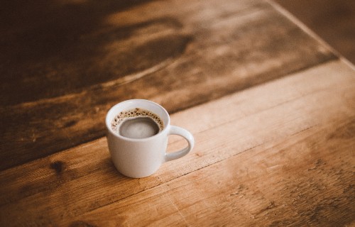 Image white ceramic mug on brown wooden table