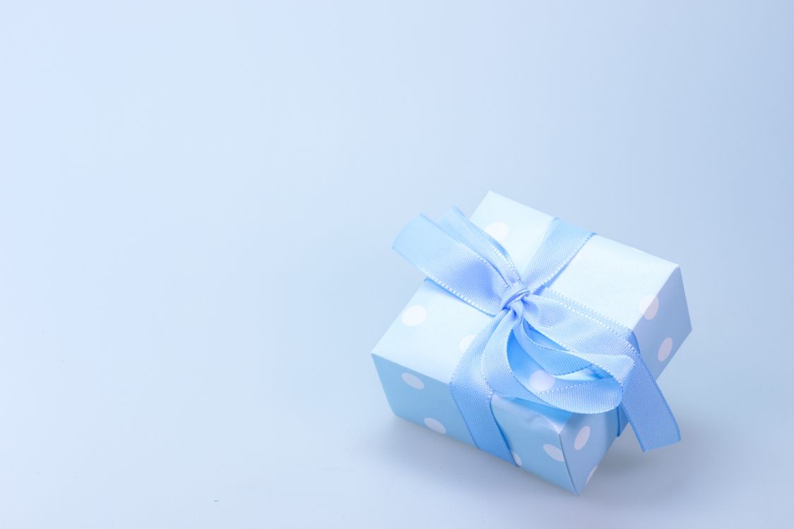 blue and white polka dot gift box with white ribbon