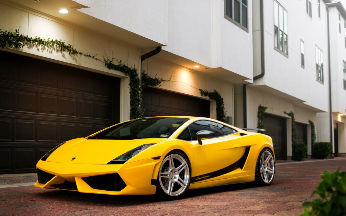 yellow ferrari 458 italia parked near white building