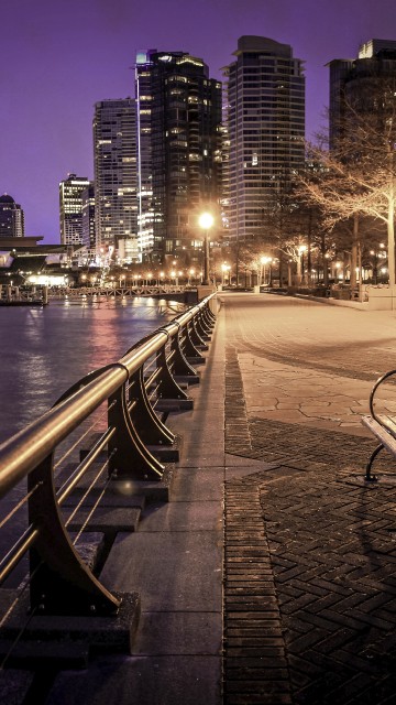 Image gray concrete bridge near city buildings during night time