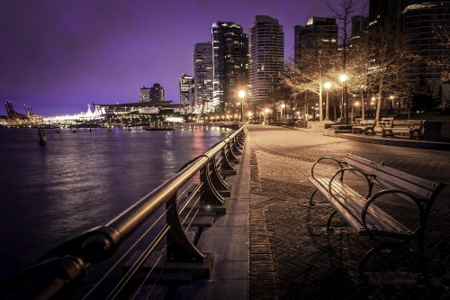 Image gray concrete bridge near city buildings during night time