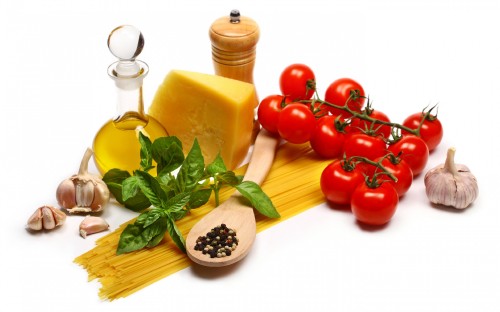 Image red tomatoes beside yellow cheese and yellow container