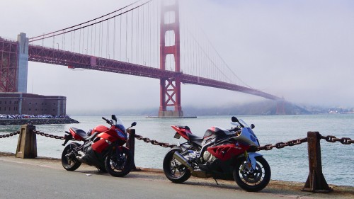 Image red and black motorcycle near golden gate bridge