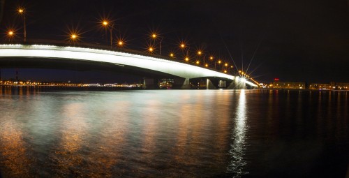 Image white bridge over body of water during night time