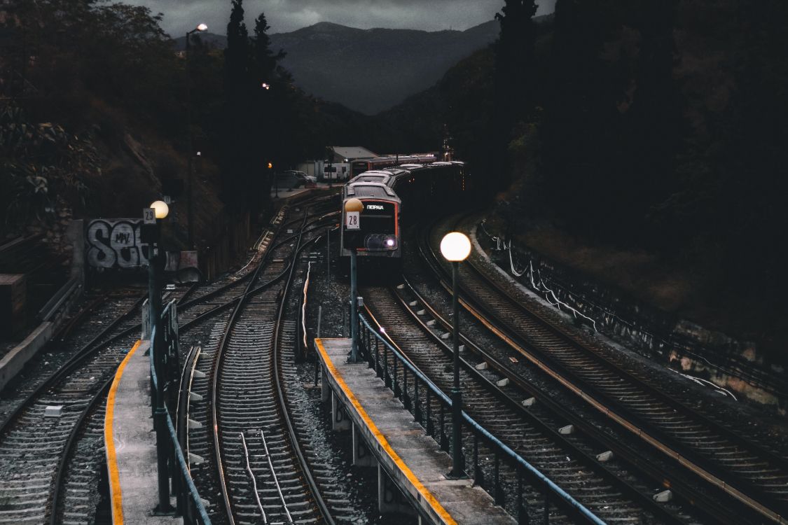 train on rail road during daytime