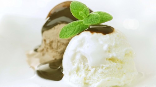 Image ice cream with green leaf on white ceramic plate