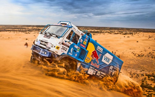 Image blue and white suv on brown sand during daytime