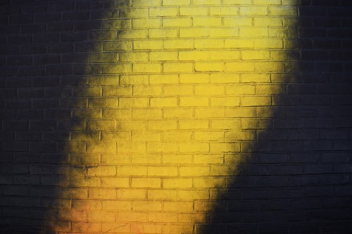 Image brown and black brick wall