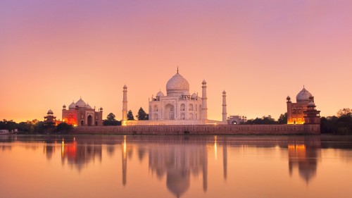 Image white dome building near body of water during sunset