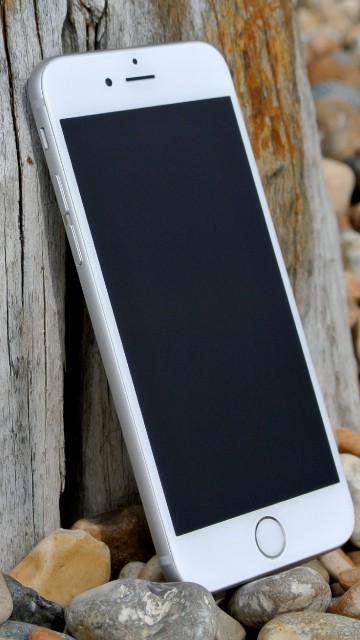 Image silver iphone 6 on brown wooden table