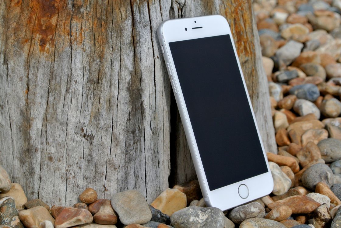 silver iphone 6 on brown wooden table