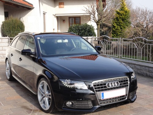 Image blue audi a 4 coupe parked on sidewalk during daytime