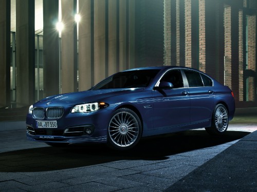 Image blue mercedes benz sedan parked beside gray building