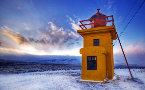 Image white concrete building on snow covered ground under cloudy sky during daytime