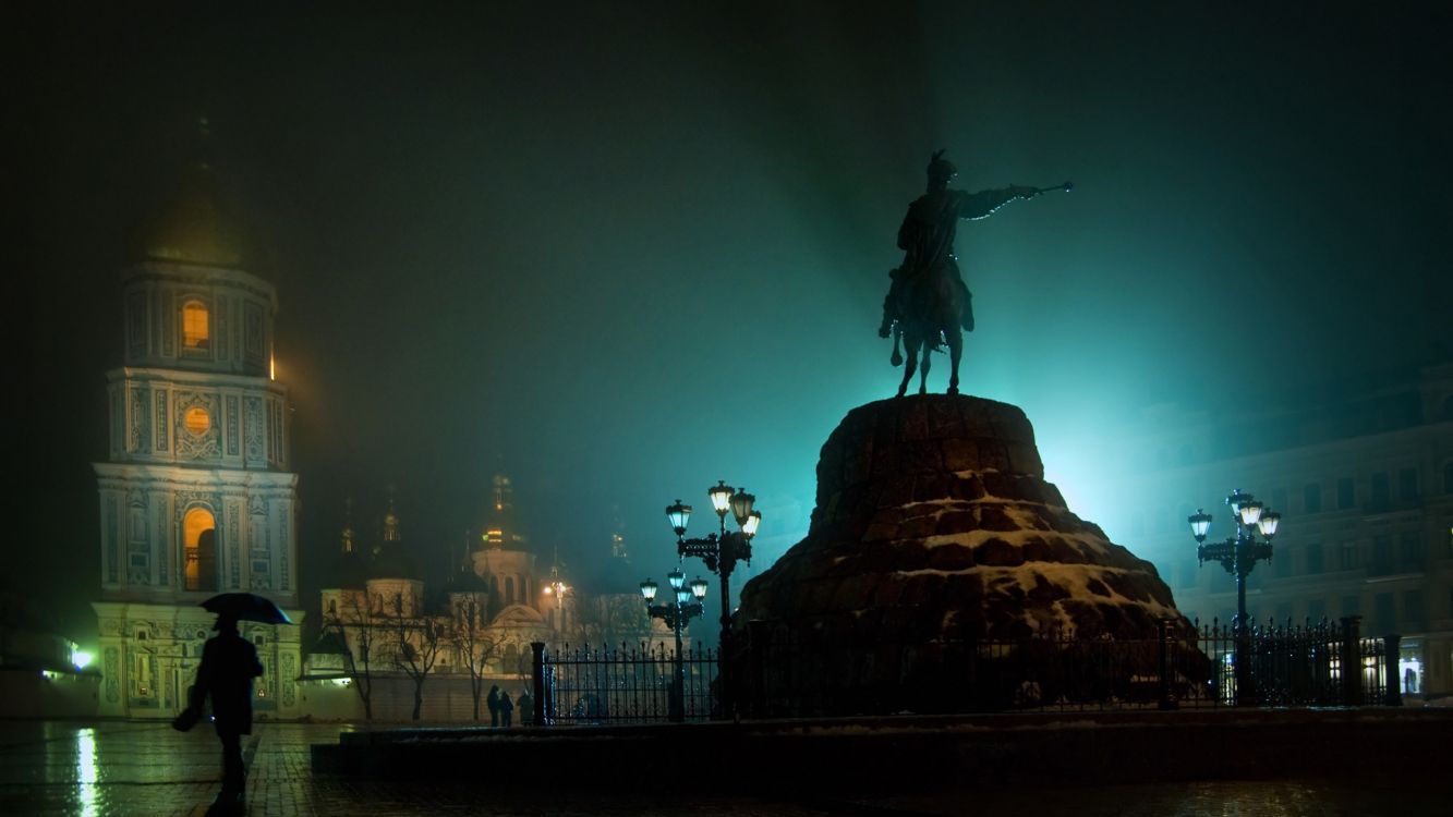 statue of man riding horse during night time