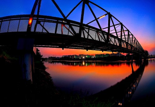 Image silhouette of bridge over body of water during sunset