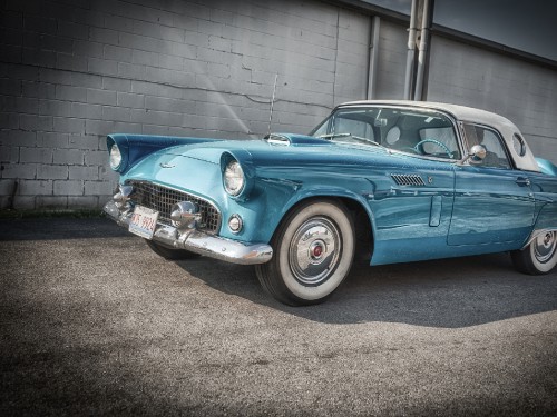 Image blue classic car parked on gray concrete pavement during daytime