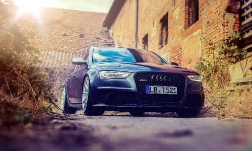 Image black audi r 8 parked beside brown brick wall