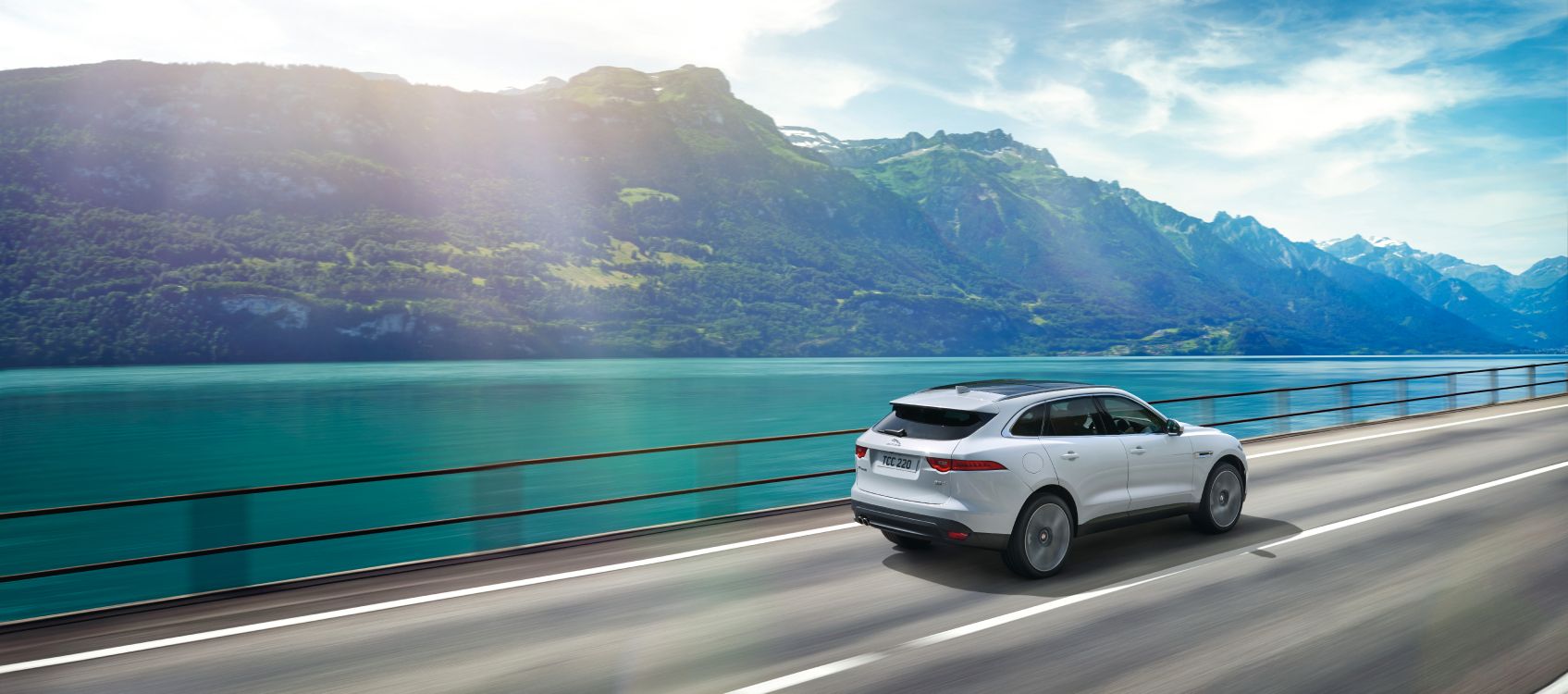 Suv Blanco en la Carretera Cerca Del Cuerpo de Agua Durante el Día. Wallpaper in 11102x4912 Resolution