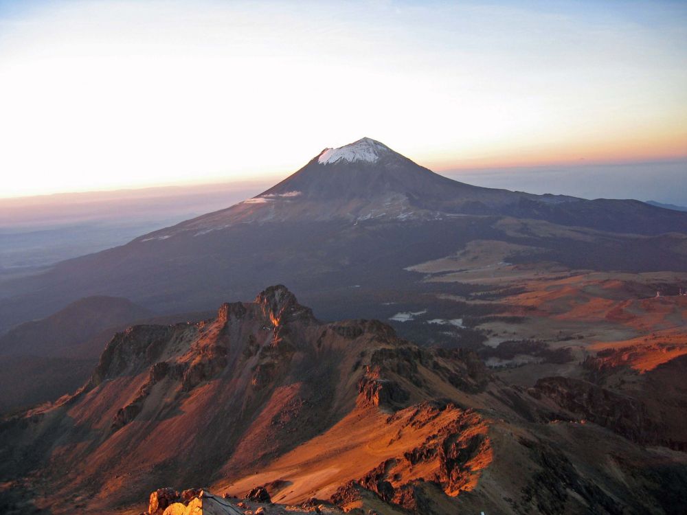 brown and white mountain under white clouds during daytime