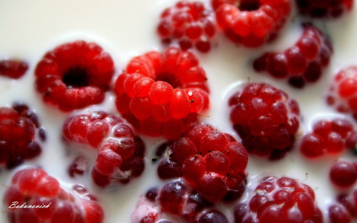 red raspberries on white ceramic plate