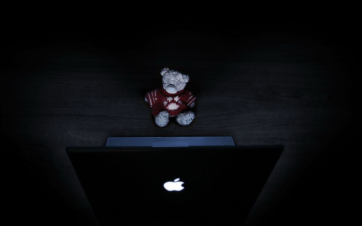 red bear plush toy on macbook