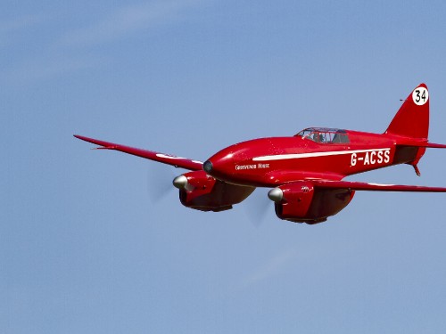 Image red and white jet plane in mid air