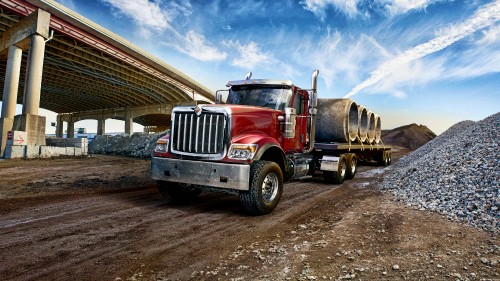 Image red and white freight truck on road during daytime