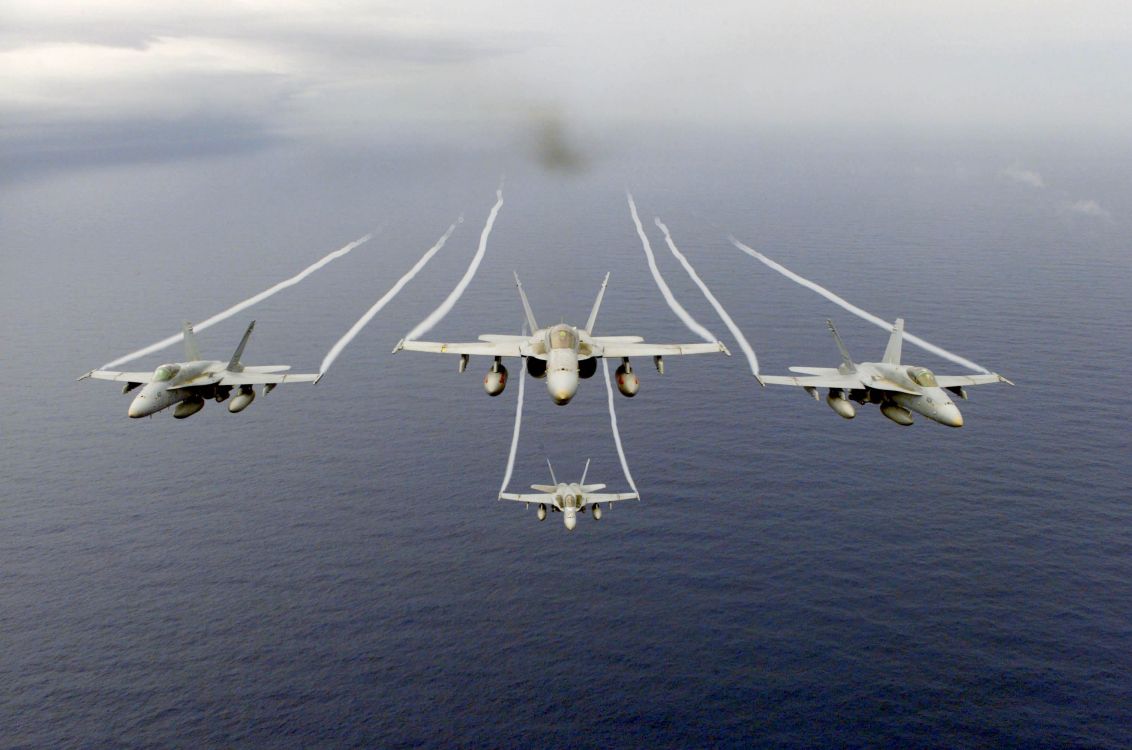 white jet plane on mid air during daytime