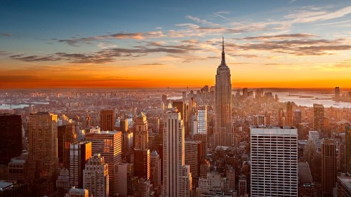 Image aerial view of city buildings during sunset