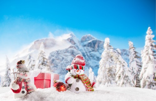 Image red and white santa claus on snow covered ground during daytime